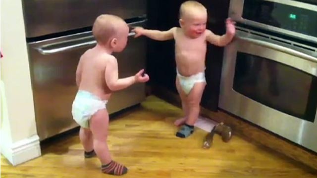 PHOTO Twin boys have a conversation together in baby talk.