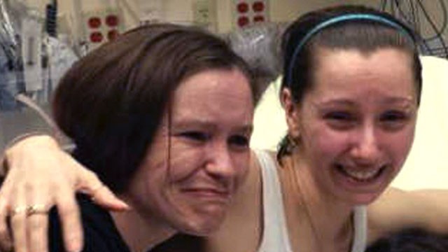 PHOTO: Amanda Berry, right, hugs her sister Beth Serrano after being reunited in a Cleveland hospital, May 6, 2013.