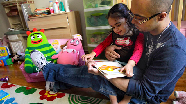 PHOTO: Christopher Astacio reads with his daughter Cristina, 2, recently diagnosed with a mild form of autism, in her bedroom, March 28, 2012 in New York.