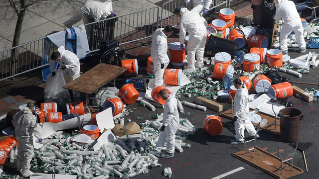 PHOTO: Investigators comb through the post finish line area of the Boston Marathon at Boylston Street, two days after two bombs exploded just before the finish line, April 17, 2013, in Boston.
