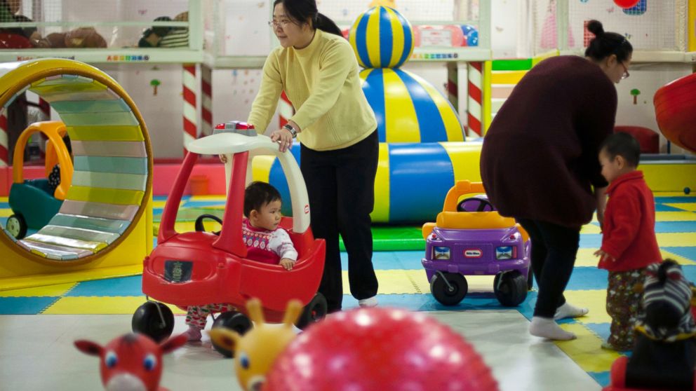 PHOTO: In this Jan. 10, 2013 photo, parents play with their children at a kids play area in a shopping mall in Beijing.