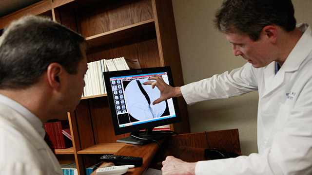 PHOTO: Doctors looking at record of patient with M.S.