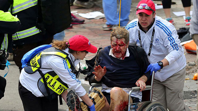 PHOTO: Medical workers aid an injured man at the 2013 Boston Marathon following an explosion in Boston, April 15, 2013.