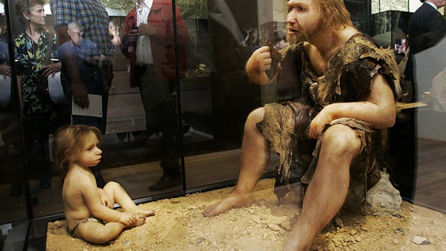 PHOTO: Visitors of the Museum for Prehistory in Eyzies-de-Tayac, France look at a Neanderthal man and child reconstruction.