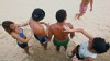 Beachgoers apply sunscreen to each other at Bondi Beach in Sydney, Australia, in this Jan. 8, 2013 photo.