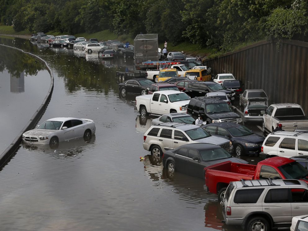 PHOTO: Vehicles sit stranded on a flooded Interstate 45 in Houston, Texas on May 26, 2015.