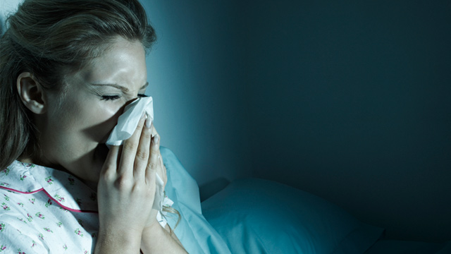PHOTO: Woman blowing her nose