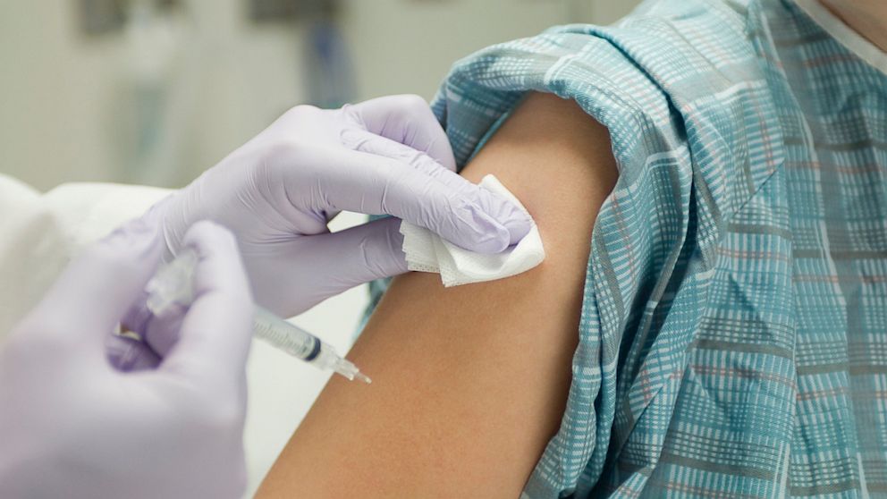 PHOTO: Doctor placing gauze on patients arm after administering a shot in this undated photo.