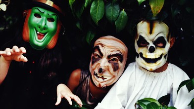PHOTO: Three children wear halloween masks.