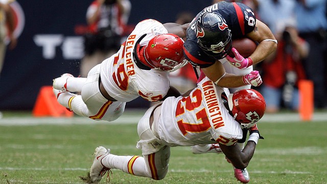 PHOTO: Linebacker Jovan Belcher #59 and cornerback Donald Washington #27 of the Kansas City Chiefs tackle Owen Daniels #81 of the Houston Texans at Reliant Stadium on Oct. 17, 2010 in Houston, Texas.