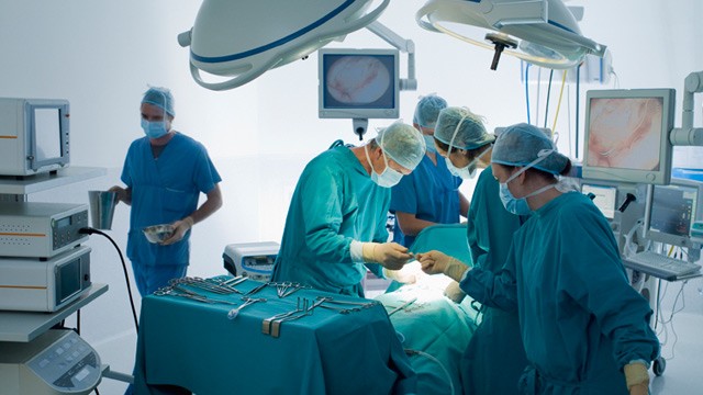 PHOTO: Surgeons performing operation in operating room