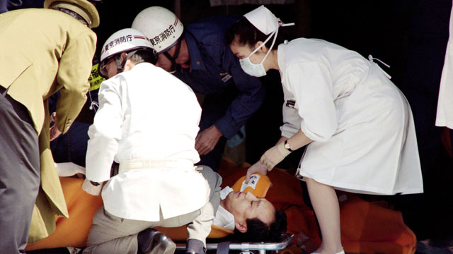 PHOTO: A commuter is treated by an emergency medical team at a make-shift shelter before being transported to hospital after being exposed to Sarin gas fumes in the Tokyo subway system during an Aum sect attack, March 20, 1995.