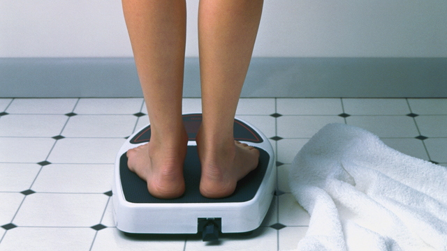 PHOTO: A woman is seen standing on a scale in this undated stock photo.