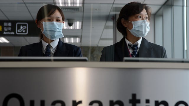 PHOTO: Taiwans Center for Disease Control staff stand at the entrance of Sungshan Airport in Taipei, April 4, 2013.