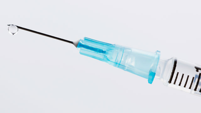 PHOTO: Close Up of Medical Syringe.