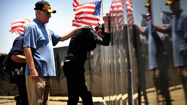 PHOTO: Vietnam Veteran Harold Evans stands with Martin Omafray at the Wall that Heals at Iron Horse Park at Fort Carson in Colorado Springs June 10, 2011.