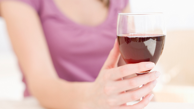 PHOTO: Woman holding glass of wine