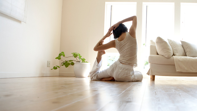 PHOTO: Woman doing yoga in living room