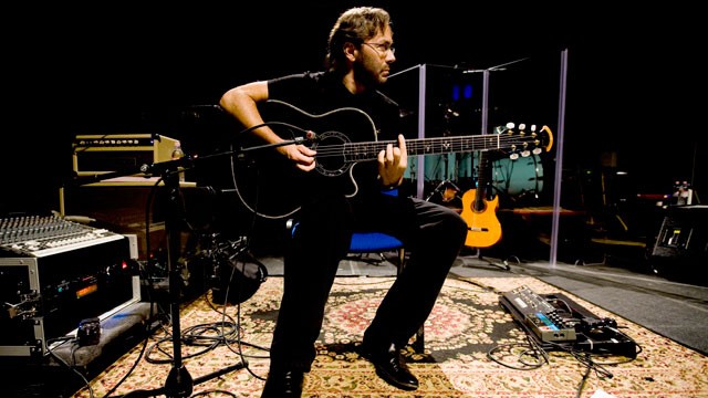 PHOTO: Al Di Meola, a guitarist, composer and record producer who has suffered from severe tinnitus since childhood, performs acoustic guitar as Plexiglas panels help protect his ears from the high volume of the drums.