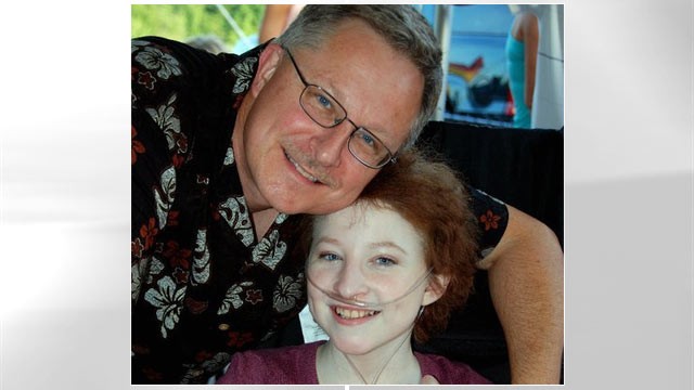 PHOTO: Esther Earl and her dad sit together the month before she died.