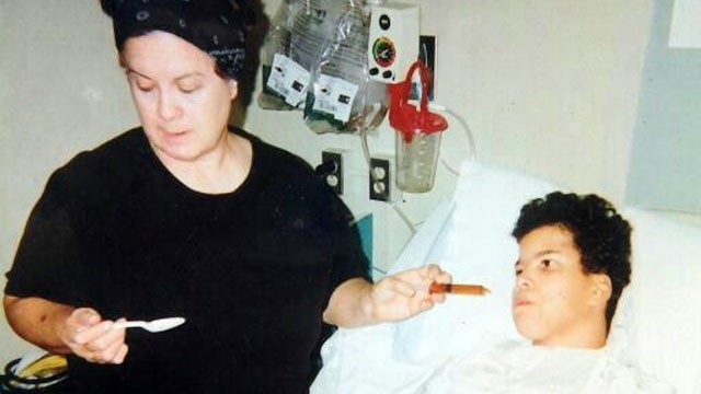 PHOTO: Doris Freyre feeds her daughter Marie, before the 14-year-old was taken to a nursing home and died in state custody.