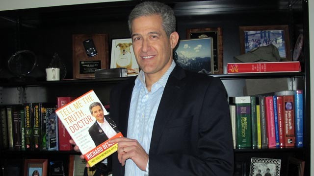 PHOTO: Dr. Richard Besser poses with his book, Tell Me The Truth, Doctor.