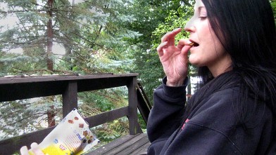 PHOTO: Mary, who is addicted to eating cat food, sitting outside eating cat food.