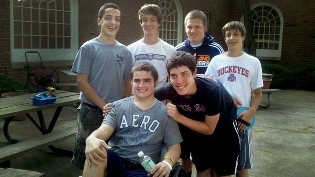 PHOTO: James Finnerty, seated, receives the support of high school friends after suffering a stroke at 15.