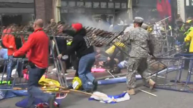 PHOTO: John Mixon, in theblack shirt, helped tear down a fence at the Boston Marathon finish line, offering his help to others.