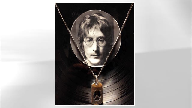 PHOTO: A pendant with a piece of John Lennons tooth in front of vinyl at the Castlepark Dental Centre in northeast England.