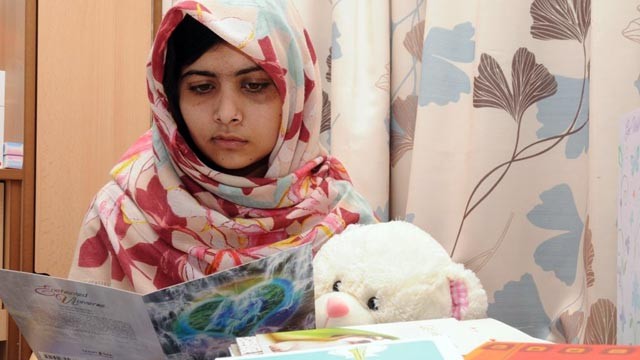 PHOTO: Malala Yousafzai reads cards from well-wishers as she recovers from surgery at the Queen Elizabeth Hospital Birmingham in the U.K.