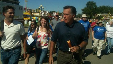 PHOTO: Mitt Romney eats a corn dog while at the Iowa State Fair.
