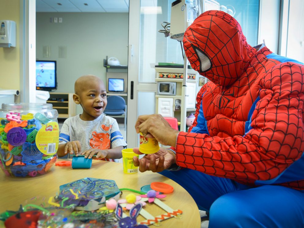 Nasir Lester, 3, and Spiderman play with Play Doh.