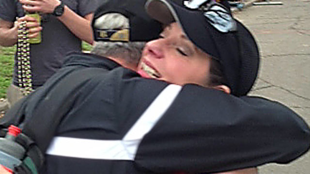 PHOTO: Toni Wild, 50, gets a hug at the finish line of her first marathon in New Orleans, Feb. 24, 2013, four years after her heart transplant.