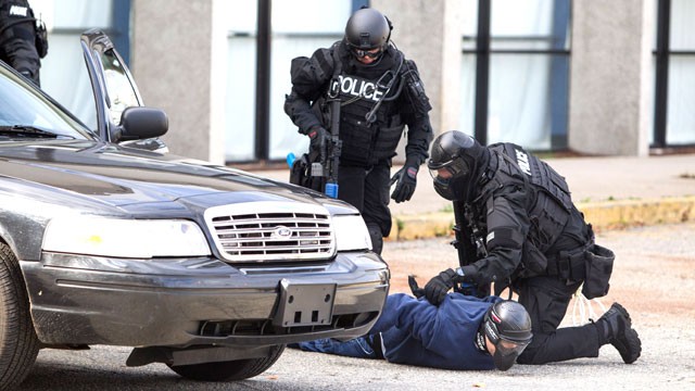 PHOTO: Members of a SWAT Team apprehend a bank robber during Urban Shield, a multi-agency, 24-hour training event where different scenarios are played out in different venues.