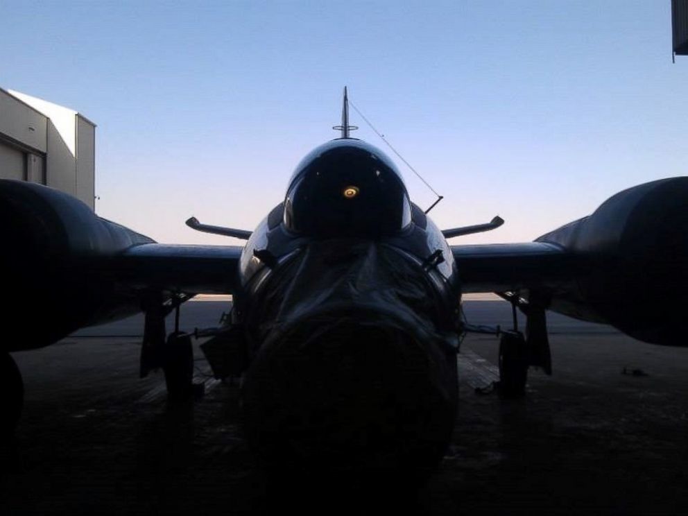PHOTO: A WB-57 shown in shadow in a hanger in Afghanistan, its nose sensor package covered to protect from dust.
