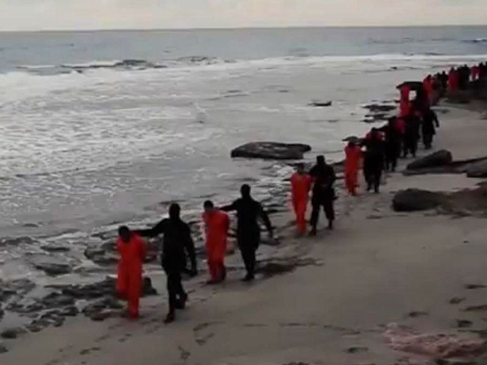 PHOTO: This file image made from a video released Feb. 15, 2015 by militants in Libya claiming loyalty to the Islamic State group purportedly shows Egyptian Coptic Christians in jumpsuits being led along a beach, each accompanied by a masked militant.