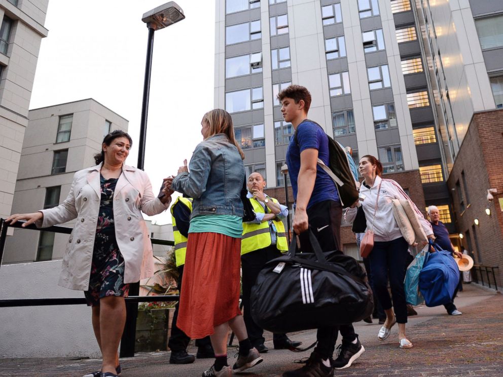 PHOTO: Residents leave a tower block on the Chalcots Estate in Camden, London, June 23, 2017, as the building is evacuated in the wake of the Grenfell Tower fire to allow urgent fire safety works to take place.