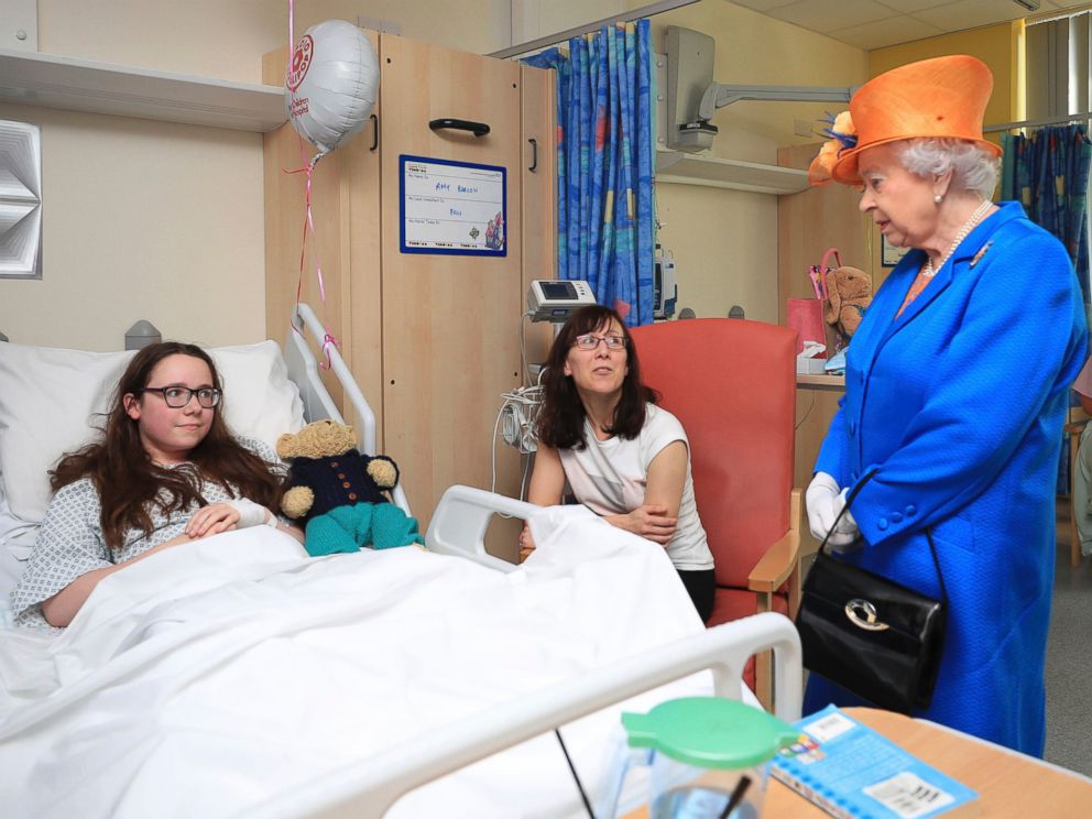 Britains Queen Elizabeth II, speaks to Amy Barlow from Rawtenstall, Lancashire and her mother, Kathy, as she visits the Royal Manchester Childrens Hospital in England, to meet victims and to thank members of staff who treated them, May 25, 2017.