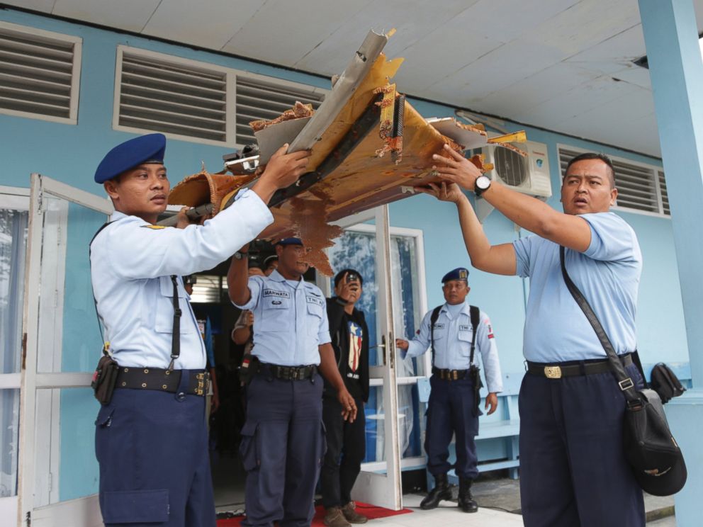 PHOTO: Indonesian air force personnel carry parts of a plane found floating on the water near the site where AirAsia Flight 8501 disappeared, at the airport in Pangkalan Bun, Indonesia, Jan. 2, 2015.