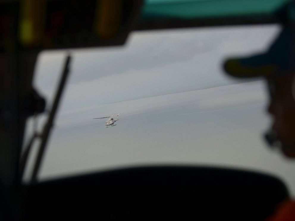 PHOTO: Indonesian navy helicopters head to navy vessel KRI Banda Aceh close to an area where a team found the tail of AirAsia Flight 8501 on the Java Sea, Indonesia, Jan. 8, 2015.