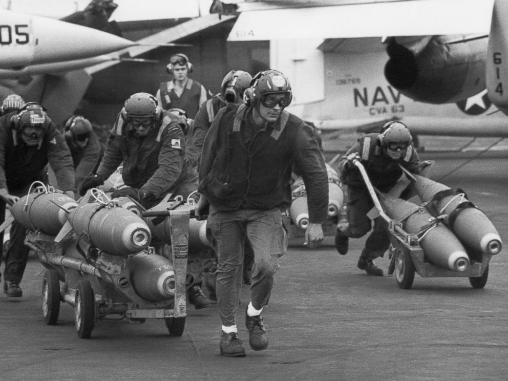 PHOTO: U.S. Navy armorers wheel out 500-pound bombs for the wing racks of jets being used in support for South Vietnamese troops fighting the enemy in Laos, on March 18, 1971. 