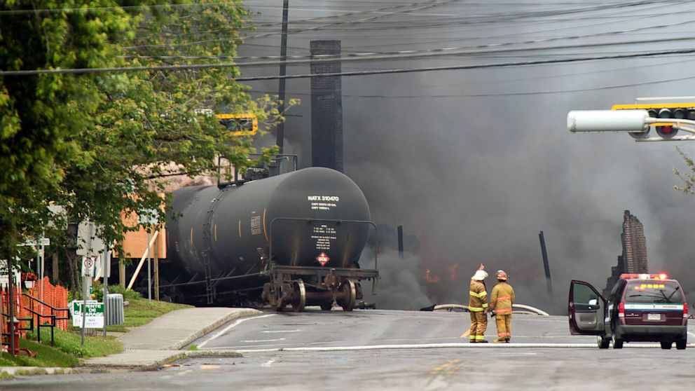 PHOTO: Smoke rises from railway cars that were carrying crude oil after derailing in downtown Lac Megantic, Quebec, Canada, Saturday, July 6, 2013. The derailment sparked several explosions and forced the evacuation of up to 1,000 people.