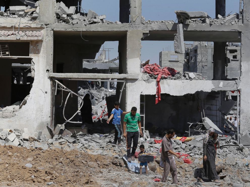 PHOTO: Palestinians carry their belongings after salvaging them from their destroyed house in the heavily bombed town of Beit Hanoun, Gaza Strip, Aug. 1, 2014.