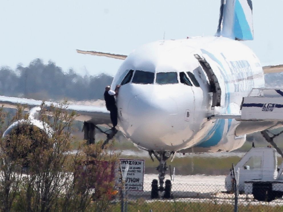 PHOTO: A person is seen here jumping out of the cockpit of EgyptAir Flight 181 at Larnaca airport in Cyprus, March 29, 2016.