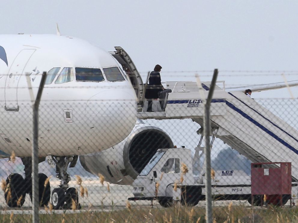 PHOTO: A passenger leaves a hijacked EgyptAir aircraft after landing at Larnaca Airport in Cyprus, March 29, 2016.