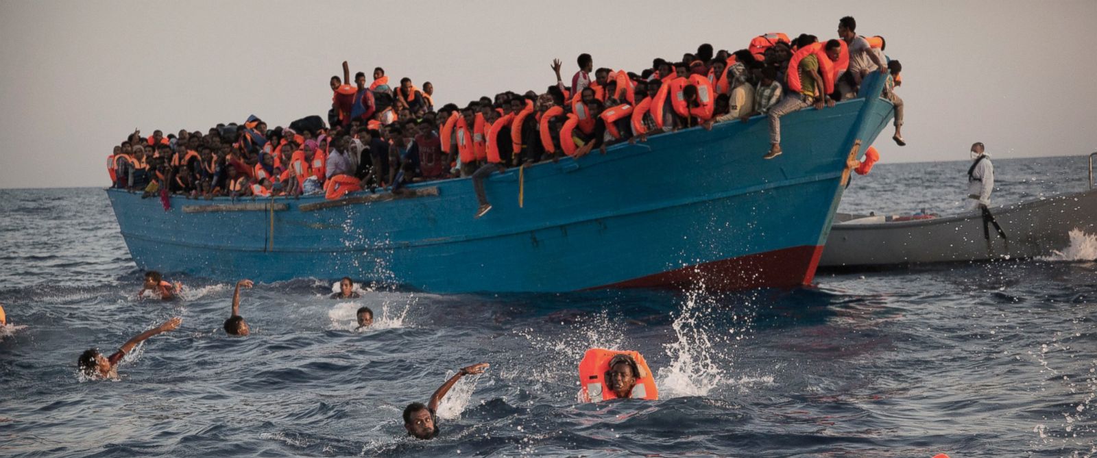 PHOTO: Migrants, most of them from Eritrea, jump into the water from a crowded wooden boat as they are helped by members of an NGO during a rescue operation at the Mediterranean sea, about 13 miles north of Sabratha, Libya, Aug. 29, 2016.