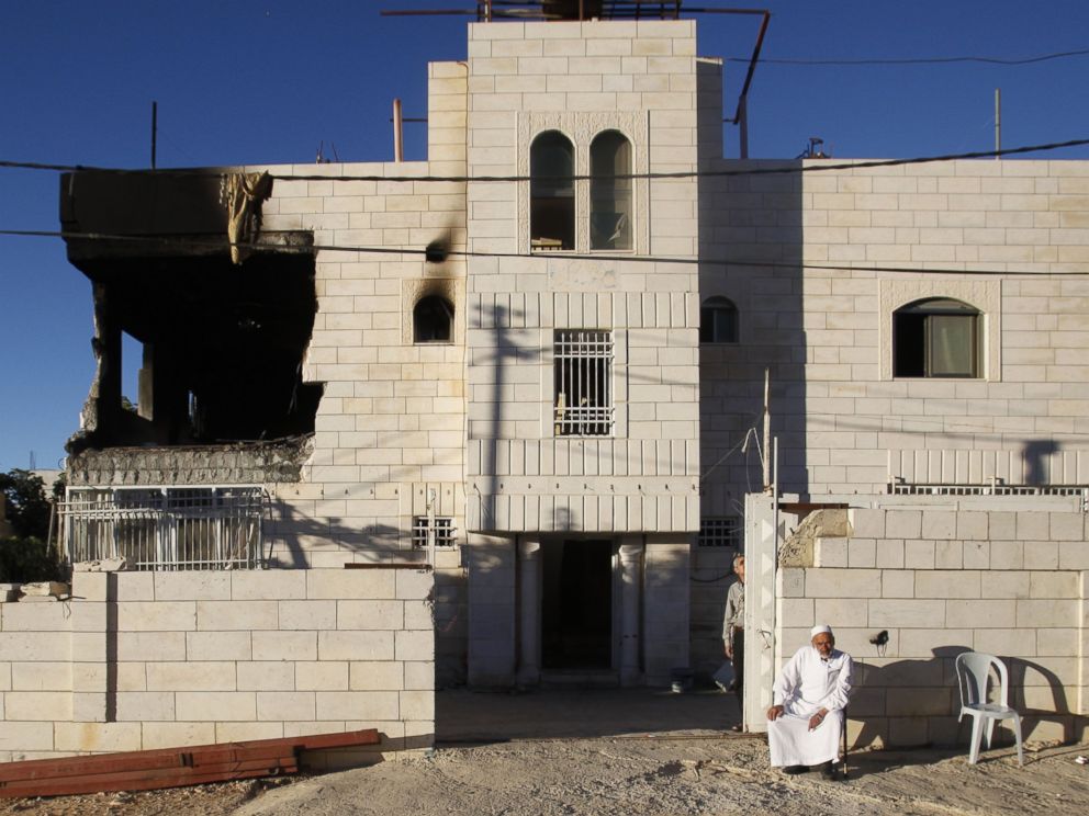 PHOTO: A Palestinian sits outside a home damaged by the Israeli army in the West Bank city of Hebron, July 1, 2014.