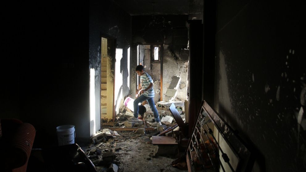 PHOTO: Palestinians inspect a demolished house after it was blown up by the Israeli army in the West Bank city of Hebron, July 1, 2014.