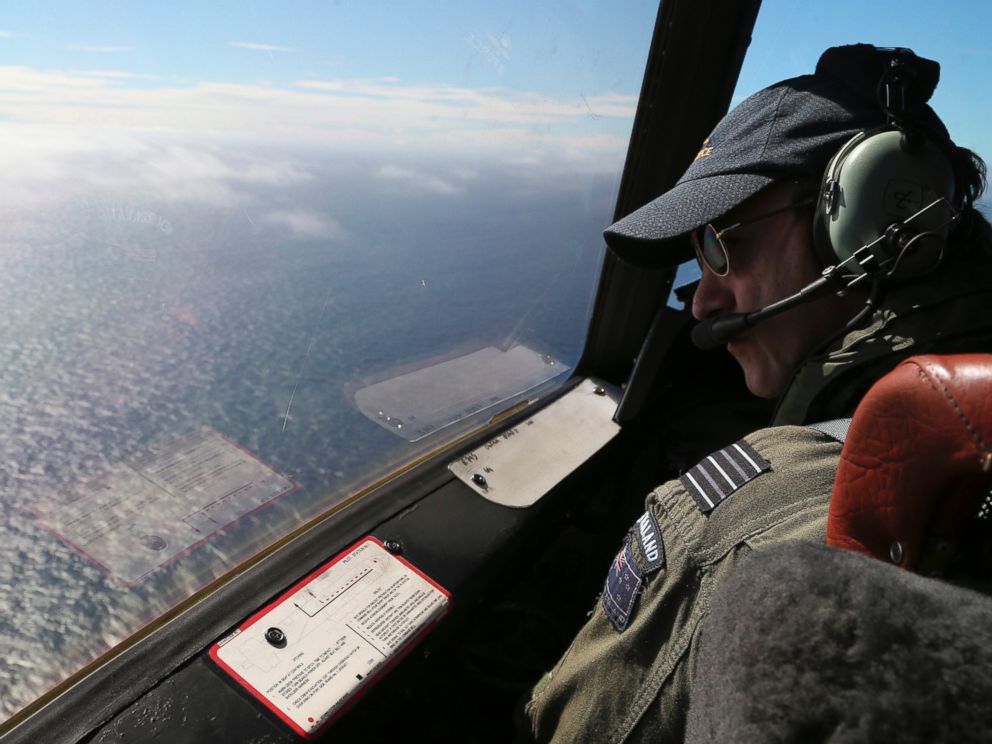 PHOTO: Royal New Zealand Air Force P-3 Orions captain, Wing Comdr. Rob Shearer watches out of the window of his aircraft while searching for the missing Malaysia Airlines Flight MH370 in the southern Indian Ocean, Monday, March 31, 2014.